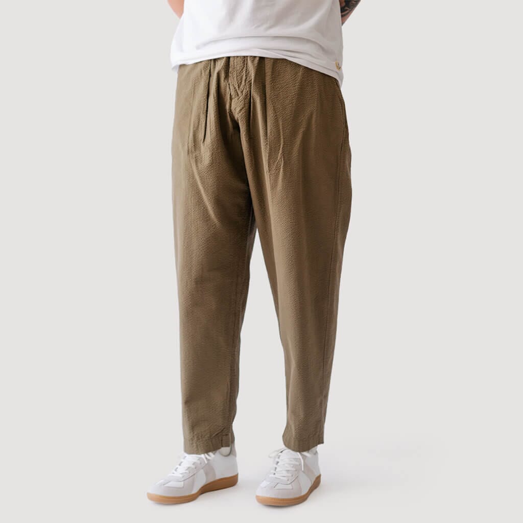 UNIVERSAL WORKS PLEATED TRACK PANT IN LIGHT OLIVE TWILL – Barkened
